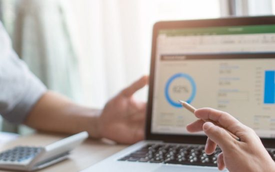 Weekly team meeting in the conference room. Close up view of business people in project pointing to laptop screen and  discussing budget financial for new project in meeting in workplace.