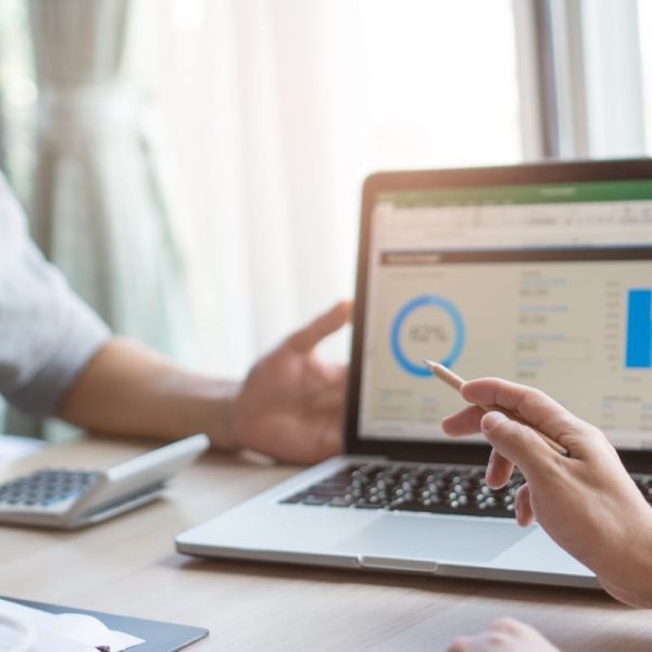 Weekly team meeting in the conference room. Close up view of business people in project pointing to laptop screen and  discussing budget financial for new project in meeting in workplace.
